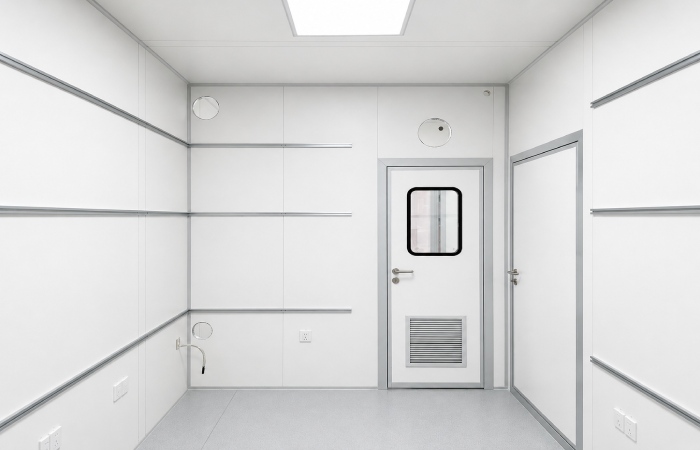 Cleanroom room with smooth wall panels flush cleanroom door service penetrations and sealed panel joints